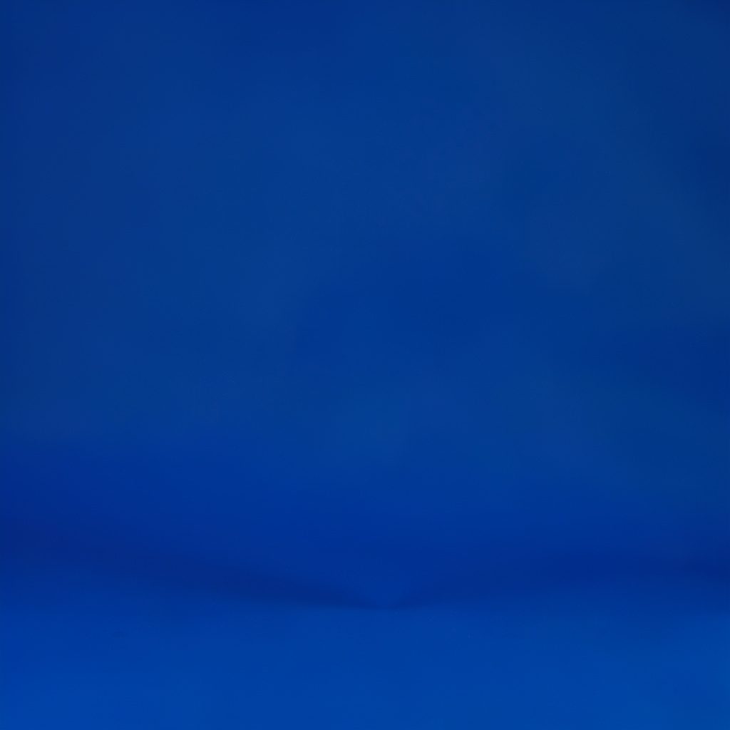 Crisp studio photograph of a sandy beach scene with gentle waves on a seamless backdrop